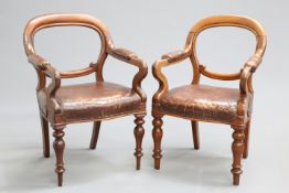 A PAIR OF EARLY VICTORIAN OAK AND LEATHER UPHOLSTERED LIBRARY CHAIRS, each with leather pads to