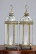 A PAIR OF PERIOD STYLE GILT METAL HANGING LANTERNS, each with domed top and hinged door. 78cm high