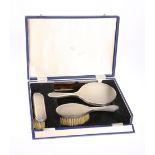 AN ELIZABETH II SILVER FOUR PIECE DRESSING TABLE SET, London 1964, comprising two brushes, mirror