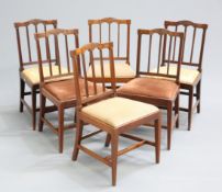 A SET OF SIX GEORGE III MAHOGANY DINING CHAIRS, each with leaf-carved crest rail and reeded bar-back