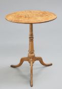 A SMALL GEORGE III OAK TRIPOD TABLE, the oval top raised on a turned stem continuing to hipped