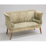 A SMALL REGENCY SETTEE, with scrolling ends, raised on splayed square-section legs, moving on