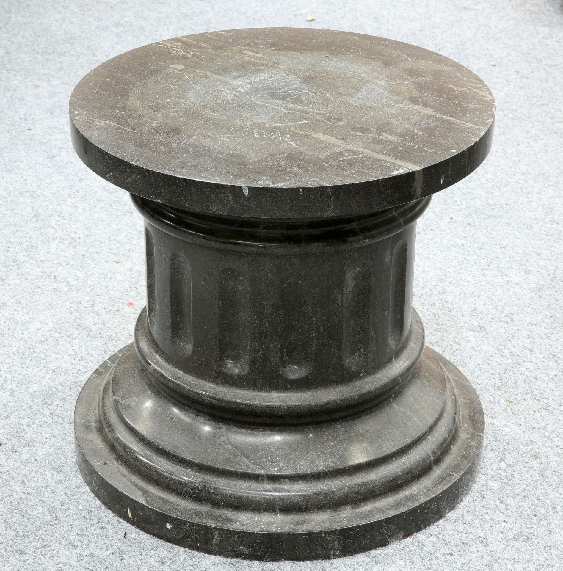 A FLUTED MARBLE PLINTH. 40cm highThe absence of a Condition Report does not imply that a lot is