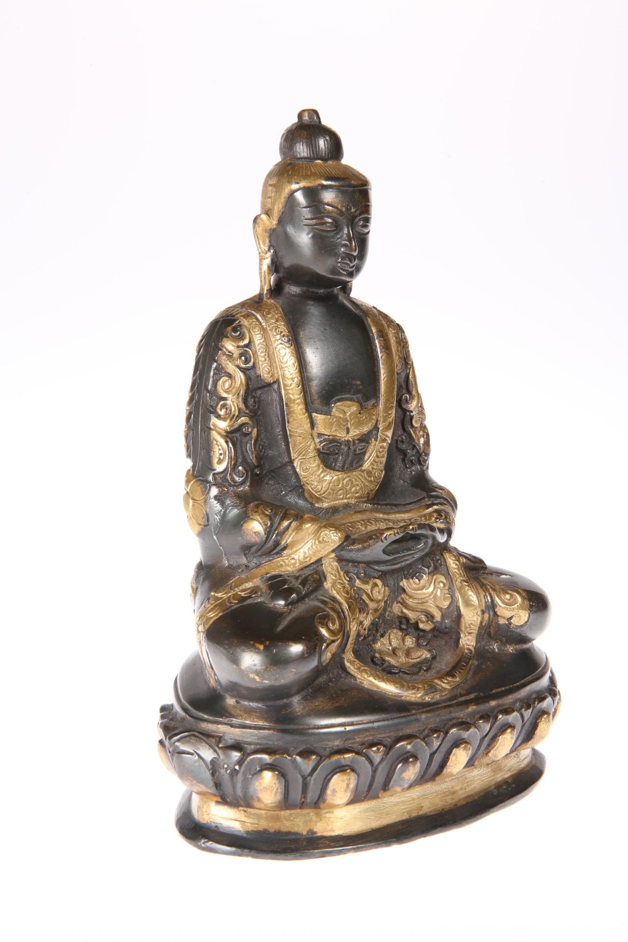 A CHINESE BRONZE FIGURE OF BUDDHA SHAKYAMUNI, 19TH CENTURY, modelled seated, partially gilded. 19.