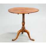 AN 18TH CENTURY YEW WOOD TILT-TOP TRIPOD TABLE, the circular top raised on a baluster stem