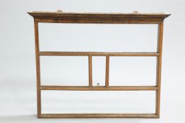 AN 18TH CENTURY OAK PLATE RACK, with moulded cornice and open shelves. 108.5cm highThe absence of