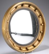 A REGENCY STYLE GILT COMPOSITION CONVEX MIRROR, the circular frame with applied balls. 41cm