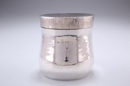 A SILVER TEA CADDY, by Graham Whatling, London 1974, baluster form with lightly hammered decoration,