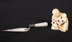A 19TH CENTURY JAPANESE IVORY NETSUKE, carved seated holding a board, unsigned, 3.4cm high; together