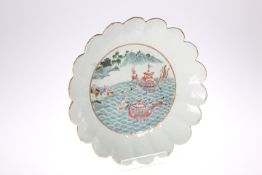 A CHINESE FAMILLE VERTE 'LOTUS' DISH, enamel painted to the well with dragon boats approaching the