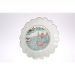 A CHINESE FAMILLE VERTE 'LOTUS' DISH, enamel painted to the well with dragon boats approaching the