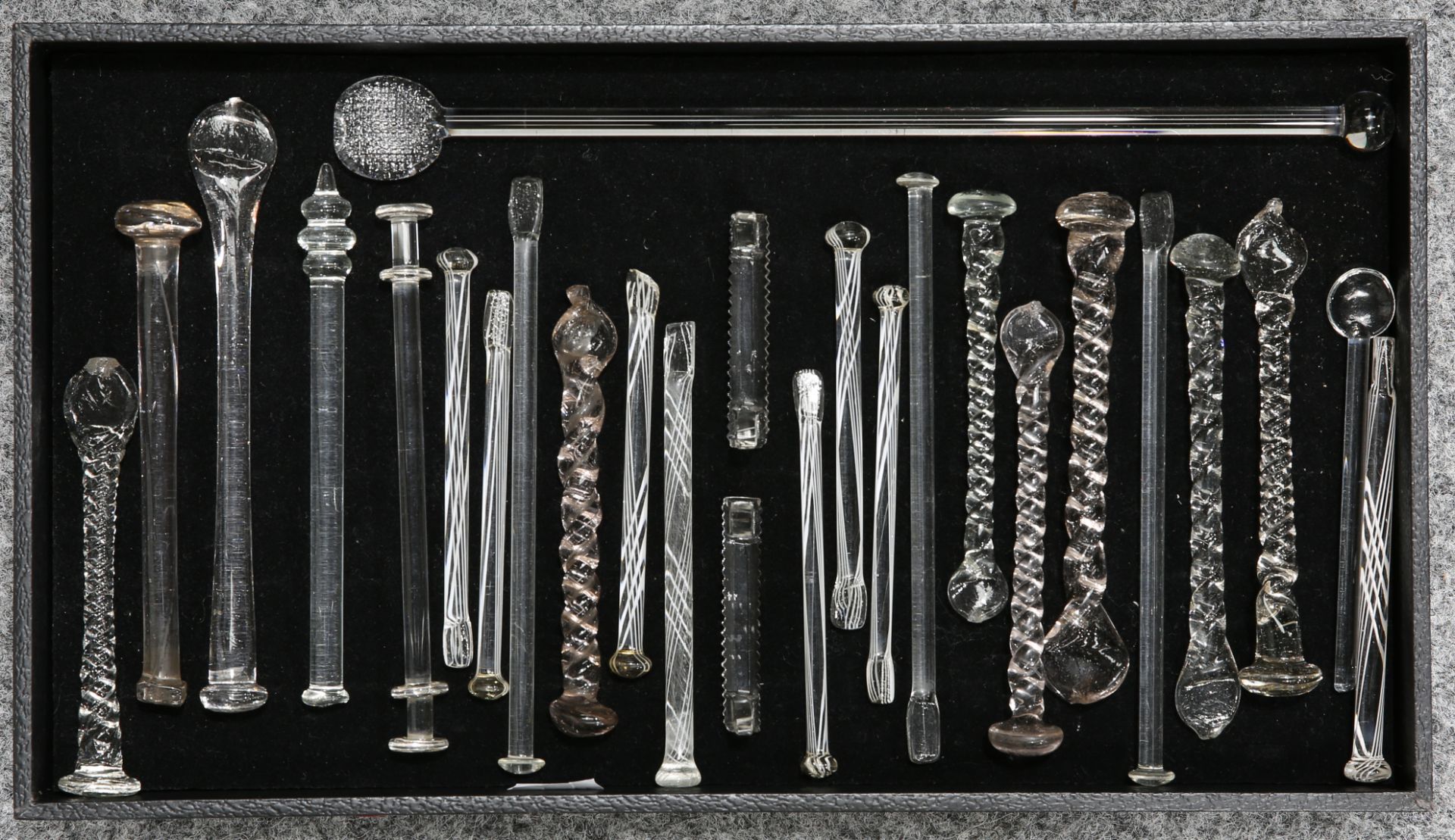 A COLLECTION OF GEORGIAN AND LATER TODDY STICKS, STIRRERS, SUGAR CRUSHERS, etc., of clear glass,