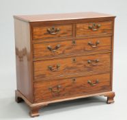 A GEORGE III MAHOGANY CHEST OF DRAWERS, the moulded rectangular top above two short and three long