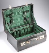 AN EDWARDIAN LEATHER TRAVELLING VANITY CASE, with green silk lined interior. 45.5cm wide