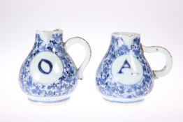 TWO ARITA BLUE AND WHITE CRUET JUGS, EDO PERIOD, CIRCA 1700, labelled 'O' and 'A' front and back,