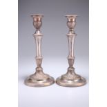 A PAIR OF 19TH CENTURY SILVER-PLATED CANDLESTICKS, each decorated with reed borders and wrythen