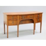 A REGENCY STYLE MAHOGANY BOWFRONTED SIDEBOARD, fitted with an arrangement of drawers and cupboard