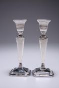 A PAIR OF SILVER CANDLESTICKS, by E.J. Houlston, Birmingham 1928, tapering square columns, topped by