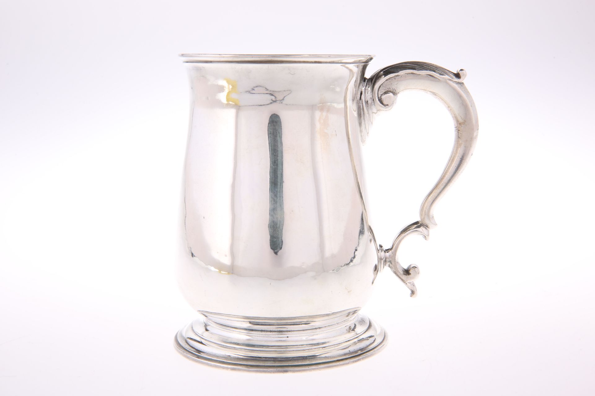 A GEORGE II SILVER MUG, by John Swift, London 1752, of baluster form with moulded foot, the