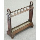 A VICTORIAN GOTHIC REVIVAL OAK STICKSTAND, with pierced trestle ends and drip tray. 72cm long