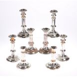 A SET OF FOUR SILVER-PLATED TELESCOPIC CANDLESTICKS, together with TWO PAIRS OF SILVER-PLATED