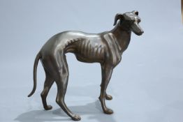 A BRONZE LIFESIZE MODEL OF A HOUND, cast standing with head turned to the right. 80cm high