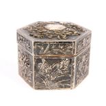 A CHINESE SILVER BOX AND COVER, CANTON, CIRCA 1880, octagonal, decorated in relied with foliage,