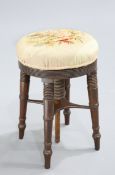A 19TH CENTURY MAHOGANY ADJUSTABLE PIANO STOOL, with circular seat, raised on four splayed ring-