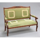 A 19TH CENTURY MAHOGANY SETTEE, in the Empire style, with scroll and foliate carved crest, the