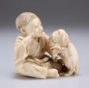 A JAPANESE IVORY NETSUKE, MEIJI PERIOD, carved as a boy playing with a dog. 6cm high