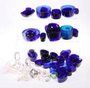 A LARGE QUANTITY OF PREDOMINANTLY BLUE GLASS LINERS, various shaped and sizes.