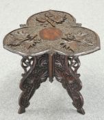 A KASHMIRI CARVED HARDWOOD OCCASIONAL TABLE, the trefoil shaped top carved in relief with foliage