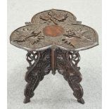 A KASHMIRI CARVED HARDWOOD OCCASIONAL TABLE, the trefoil shaped top carved in relief with foliage