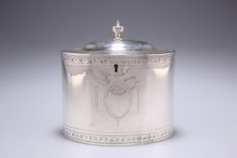 A GEORGE III SILVER TEA CADDY, makers mark overstruck, London 1787, of oval form, the hinged lid