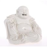 A 19TH CENTURY CHINESE BLANC DE CHINE FIGURE OF A BUDDHA, modelled seated with one hand resting on