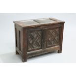 A SMALL OAK TWO-PANEL COFFER, the front panels carved with rosettes and lattice. The absence of a