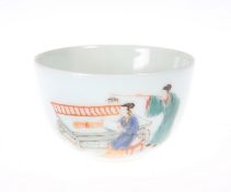 A CHINESE TEA BOWL, circular, painted with a lady reading at a table while a man attempts to scare