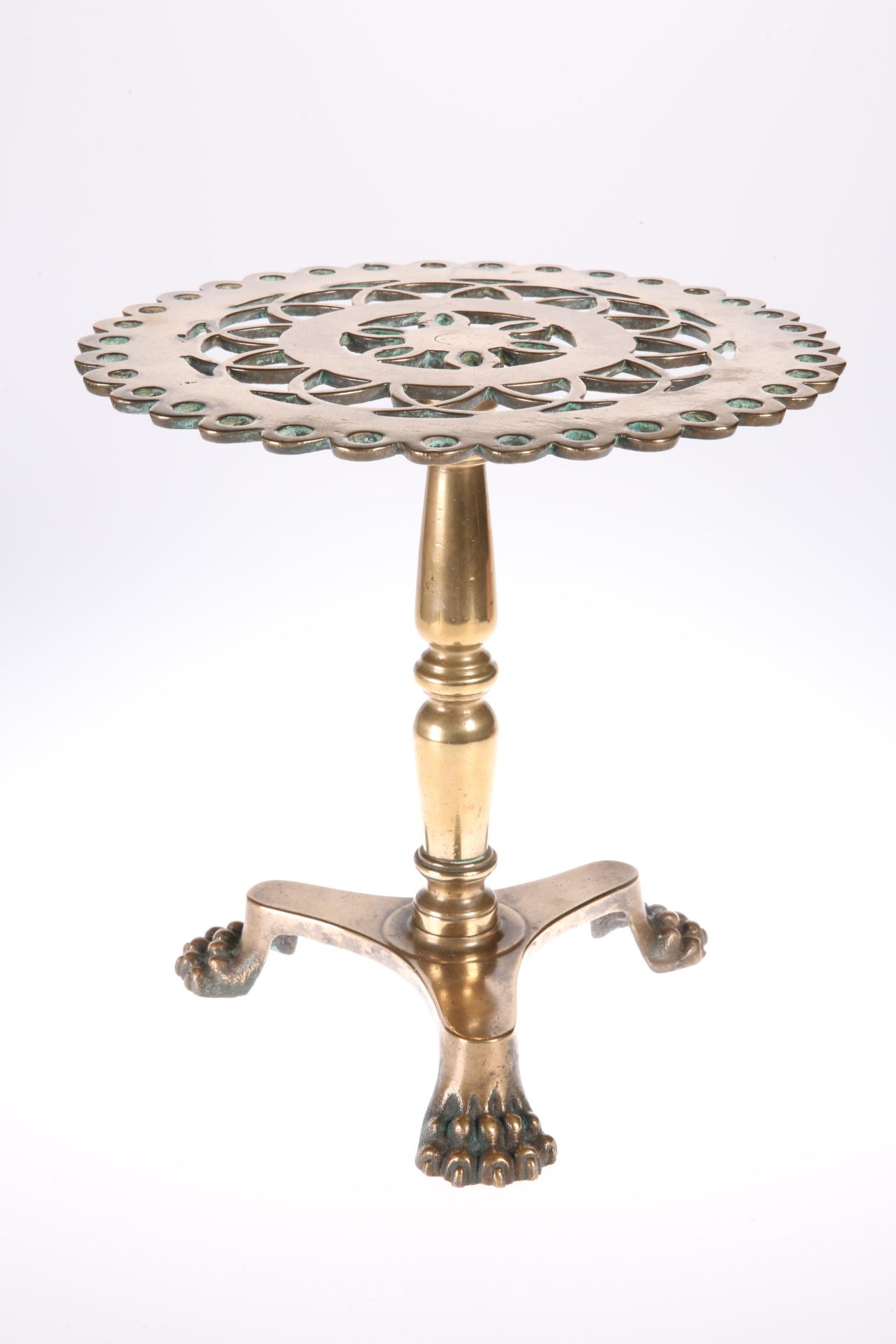 A GOOD VICTORIAN HEAVY BRASS TRIVET, in the form of a tripod table, with pierced top and triform