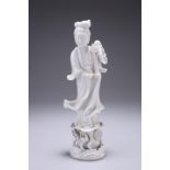 A CHINESE BLANC DE CHINE FUIGURE OF GUANYIN, modelled standing on a lotus base. 23.5cm high