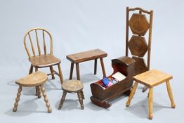 A GROUP OF FURNITURE, comprising child's chair, four stools, doll's cradle, folding cakestand. (7)