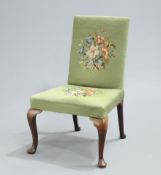 A GEORGE II WALNUT SIDE CHAIR, with needlework upholstery, raised on cabriole legs with pad feet