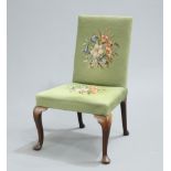 A GEORGE II WALNUT SIDE CHAIR, with needlework upholstery, raised on cabriole legs with pad feet