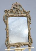 ~ A GROUP OF THREE MIRRORS, the first carved and gilded with acanthus and C-scrolls; the second gilt