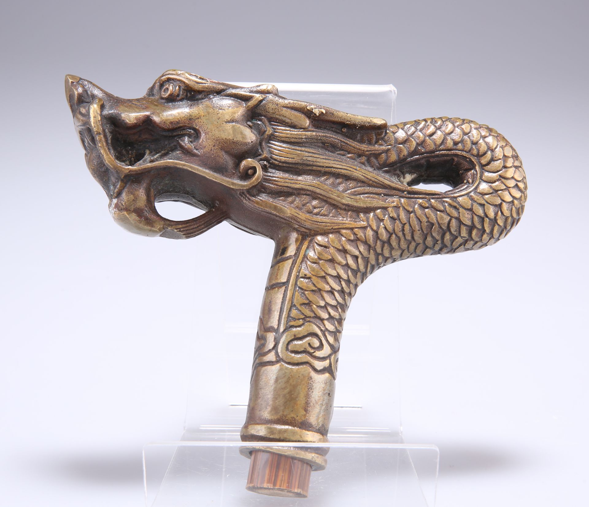 A CHINESE BRASS CANE HANDLE, in the form of a dragon's head. 12cm front to back