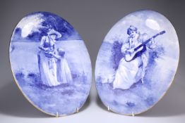 A PAIR OF ROYAL DOULTON 'BLUE CHILDREN' WALL PLAQUES, CIRCA 1905, both of oval convex form, the