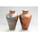 A LARGE PAIR OF SALT-GLAZED URNS, each with pierced hole to the cover. 77.5cm high