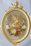 A 19TH CENTURY STUMPWORK PICTURE, depicting a Pre-Raphaelite maiden within a garland of flowers,