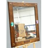 AN UNUSUAL ARTS AND CRAFTS OAK AND COPPER MIRROR, rectangular, to each corner an applied copper