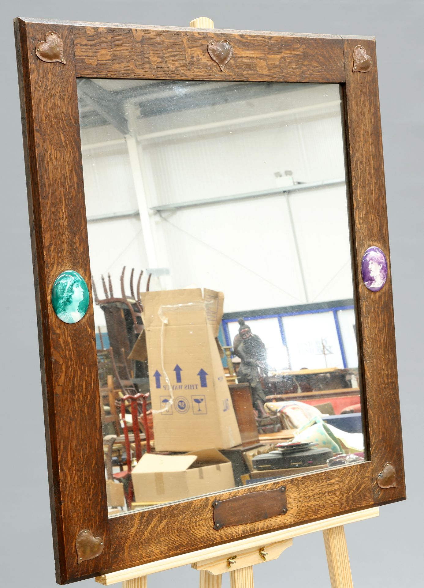 AN UNUSUAL ARTS AND CRAFTS OAK AND COPPER MIRROR, rectangular, to each corner an applied copper