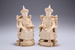 A PAIR OF CHINESE IVORY FIGURES, 19TH CENTURY, carved as a seated emperor and empress, each bears